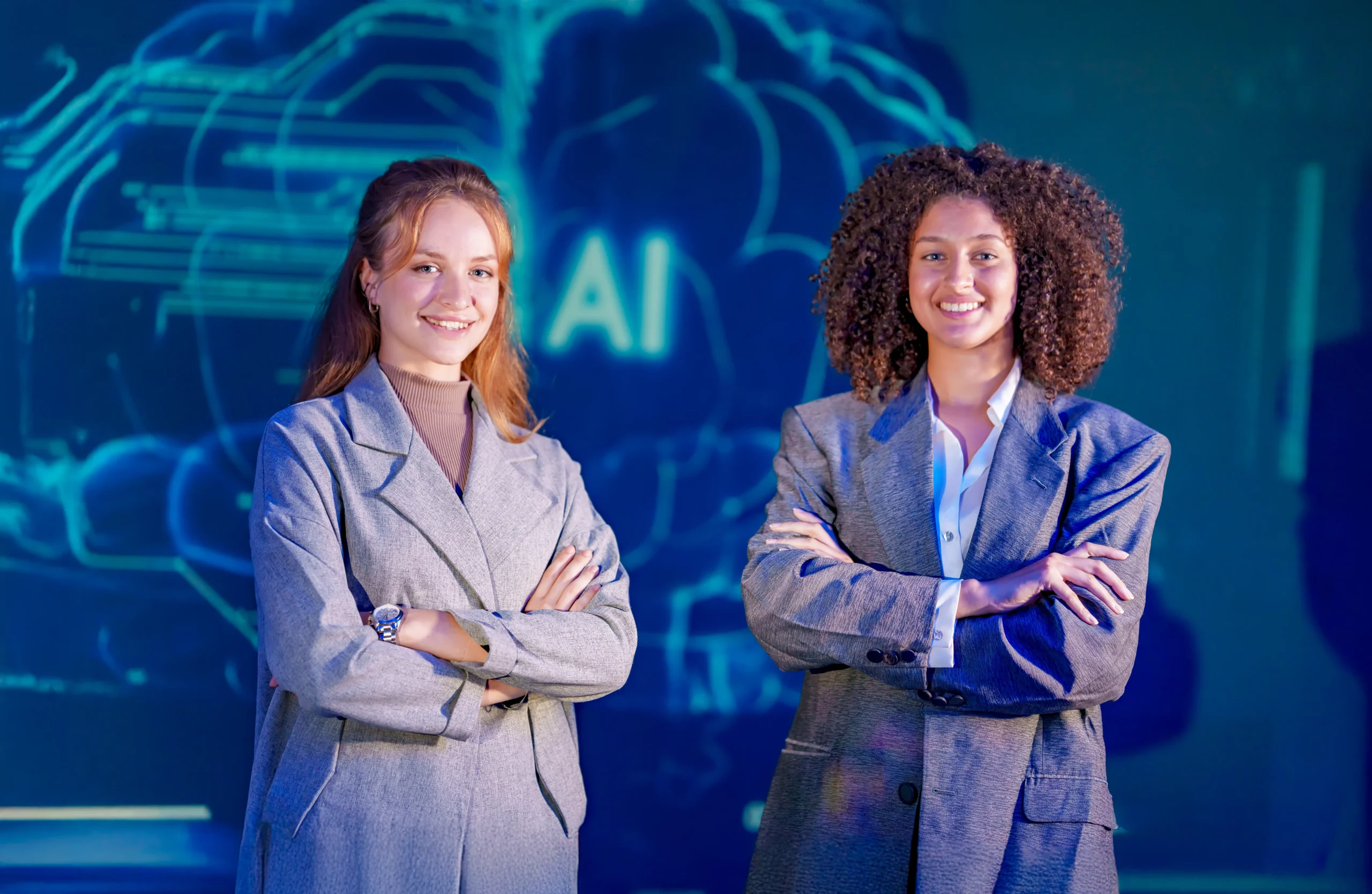 two-women-stand-together-in-suits-at-a-technology-2026-01-11-11-02-12-utc